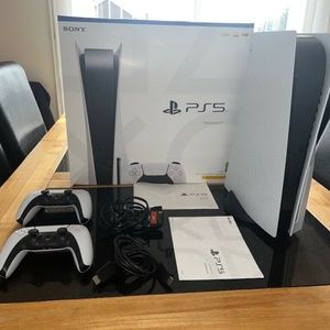 PS5 DISC EDITION + 2 Dual Sense Controllers + All cables.